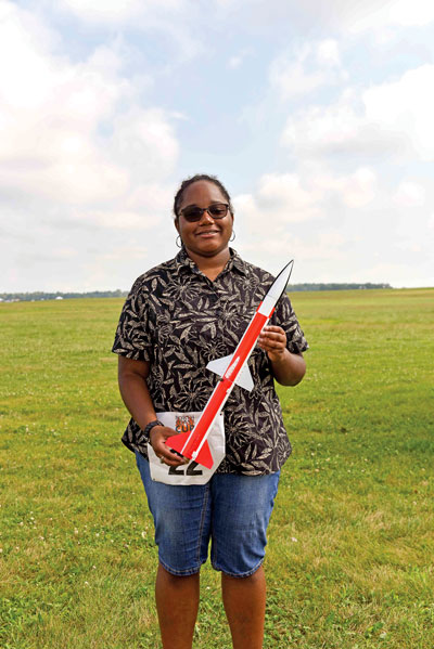 Charis Houston shows her FAI Scale entry, a Doorknob rocket.