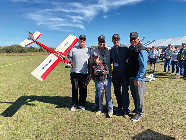 paul curry and greg yancy give an rc flight lesson to three generations of the massey family