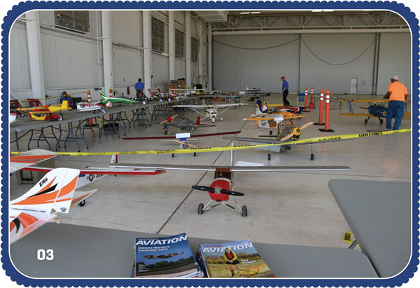 Setting up the static display. The hangar was huge and there was plenty of room for airplanes of all sizes. Maurice Morgan’s 1/3-scale Balsa USA Stearman is prominently displayed. 