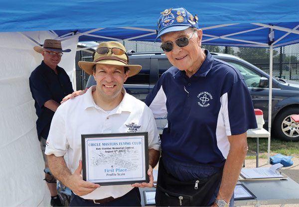 Don Adraino, from the Circle Masters Flying Club, presented the first-place trophy to Jeff Jensen for Profile Scale during the 2023 Bob Gialdini Memorial CL Championships in Mukwonago WI. 